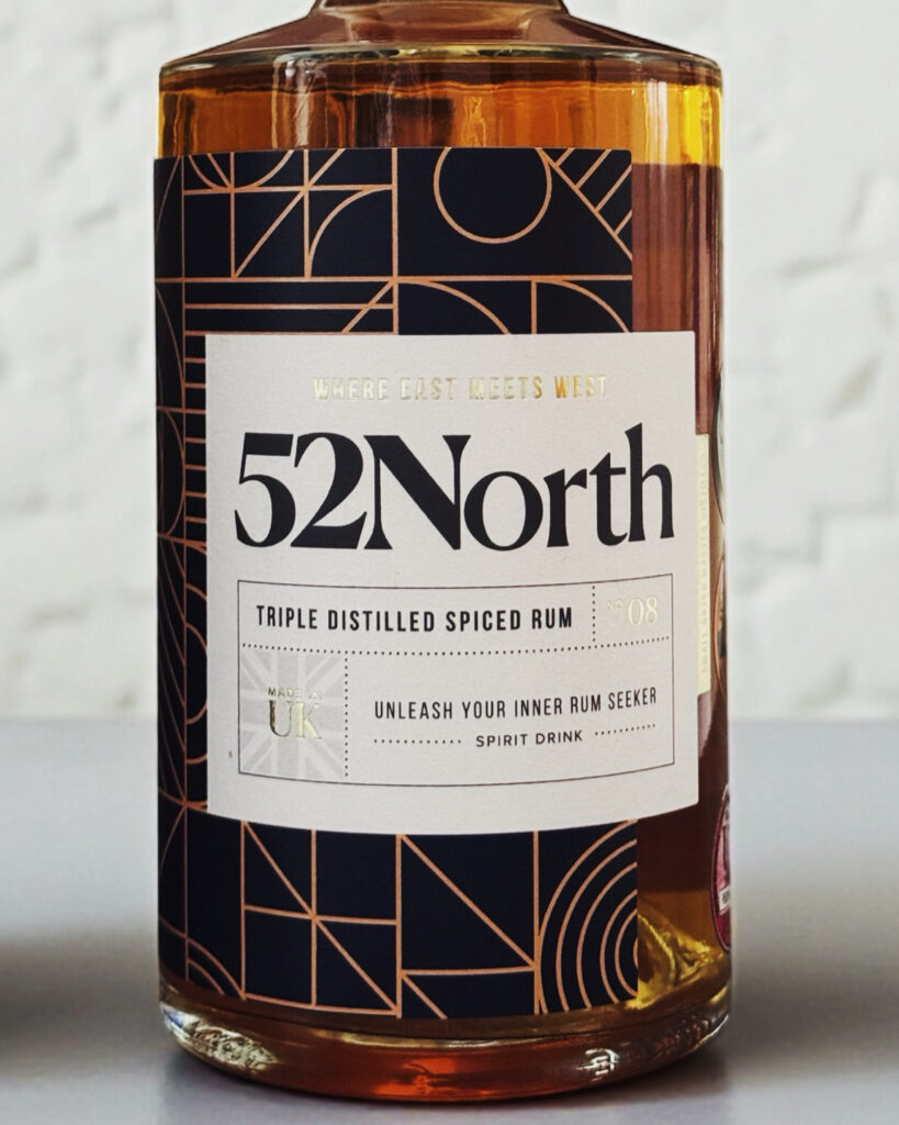 A medium closeup of a 52North Drinks Spiced Rum bottle.