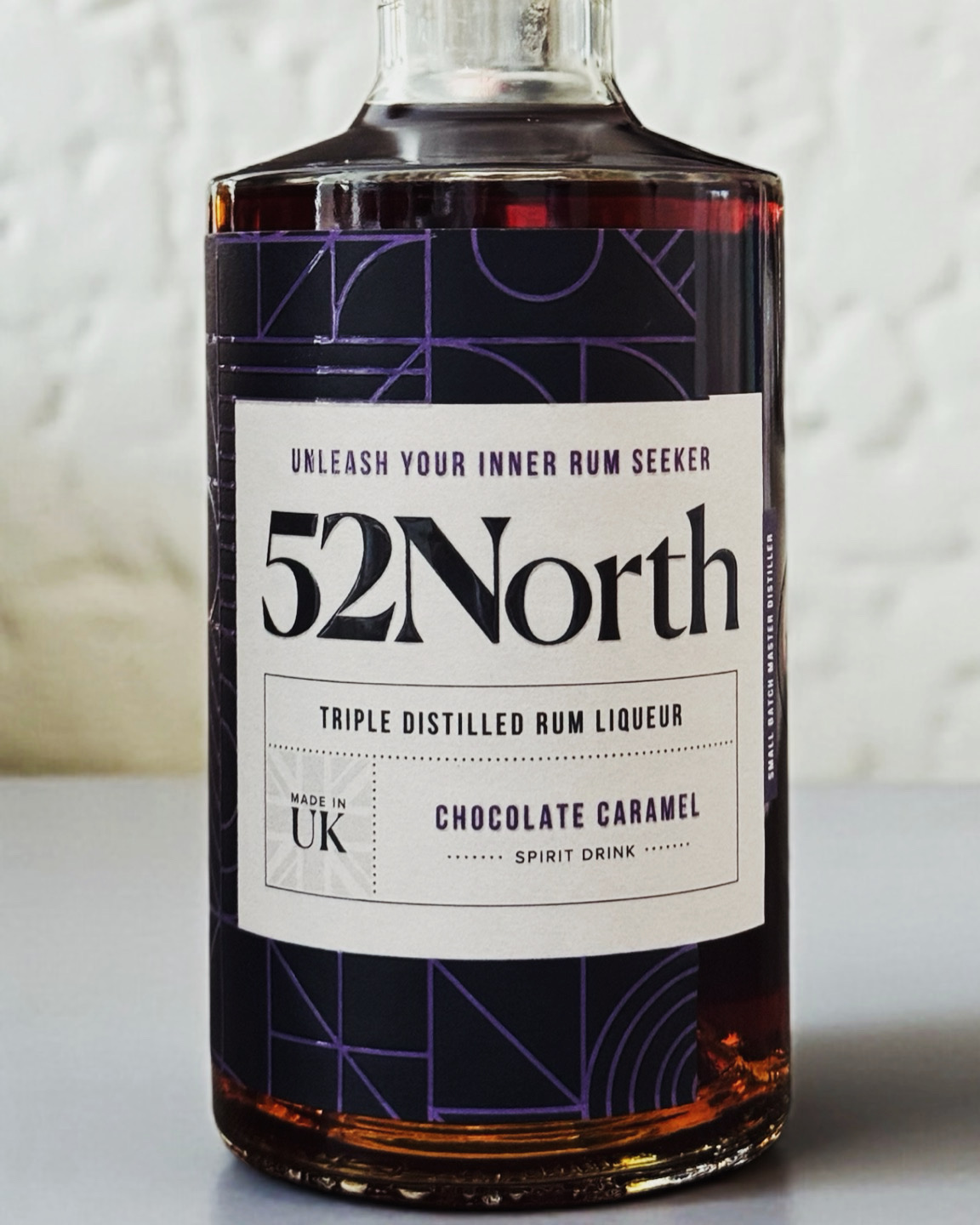 A medium closeup of a 52North Drinks Chocolate Caramel Rum Liqueur bottle.